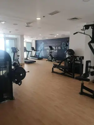a gym with several treadmills and machines in a room at Entire House in Palm Jumeriah with a Sea View in Dubai