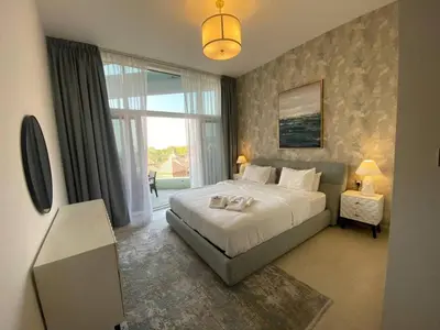 a bedroom with a bed and a large window at Sea-facing 1BHK Apartment in Palm Jumeirah in Dubai