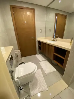 a bathroom with a toilet and a sink and a mirror at Sea-facing 1BHK Apartment in Palm Jumeirah in Dubai