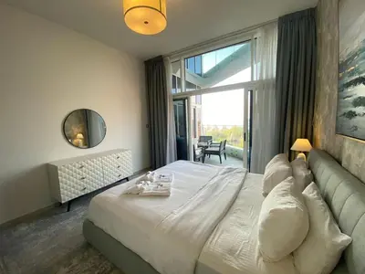 a bedroom with a large bed and a large window at Sea-facing 1BHK Apartment in Palm Jumeirah in Dubai