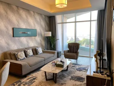 a living room with a couch and a chair at Sea-facing 1BHK Apartment in Palm Jumeirah in Dubai
