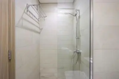 a bathroom with a shower with a glass door at Fully Equipped Studio in Meydan in Dubai