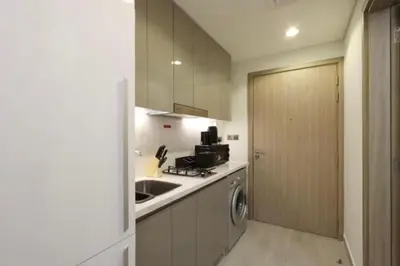 a kitchen with a sink and a washer and dryer at Fully Equipped Studio in Meydan in Dubai