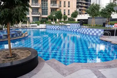 a large blue swimming pool in a building at Modern and Cozy One BHK Apt - Heart of Downtown Dubai in Dubai