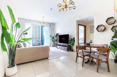 a living room with a couch and a table at Modern and Cozy One BHK Apt - Heart of Downtown Dubai in Dubai