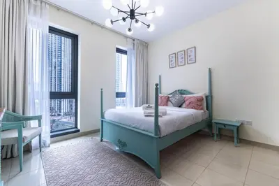 a bedroom with a bed and a chandelier at Modern and Cozy One BHK Apt - Heart of Downtown Dubai in Dubai