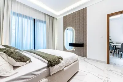 a bedroom with a bed and a mirror at Modern 1BR Apt in Azizi Riviera 51 - Pool and Gym in Dubai