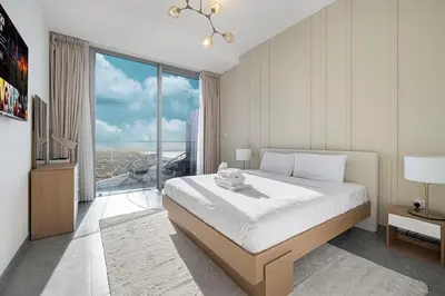 a bedroom with a large bed and a large window at Luxury 43rd Floor 2 Bedroom Apartment in Dubai Marina in Dubai