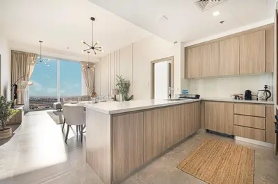 a kitchen with wooden cabinets and a large kitchen island at Luxury 43rd Floor 2 Bedroom Apartment in Dubai Marina in Dubai