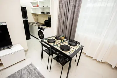 a kitchen with a table and chairs in a room at Newly Furnished Studio at city tower building in Dubai