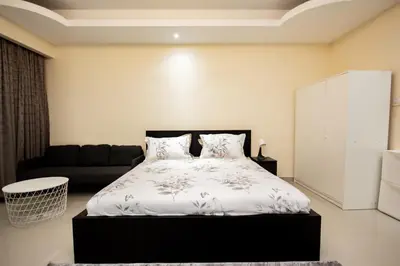 a bedroom with a bed and a couch at Newly Furnished Studio at city tower building in Dubai