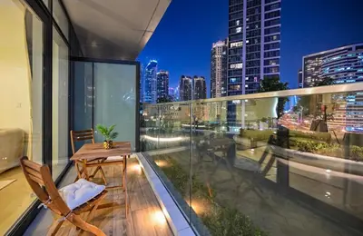 a balcony with a table and a view of the city at Luxury Condo near Burj khalifa in Dubai