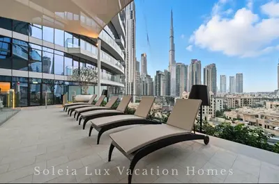 a row of chairs on a building with a view of a city at Luxury Condo near Burj khalifa in Dubai