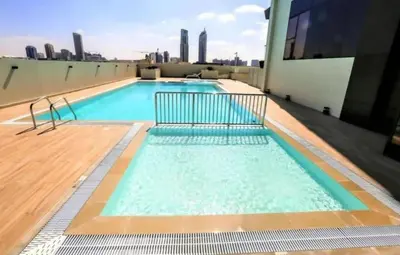 a swimming pool on the roof of a building at Luxurious cozy studio in Dubai