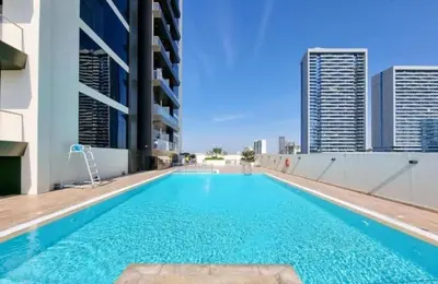 a swimming pool on the roof of a building at Luxurious cozy studio in Dubai