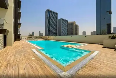 a swimming pool on the roof of a building at Luxurious cozy studio in Dubai