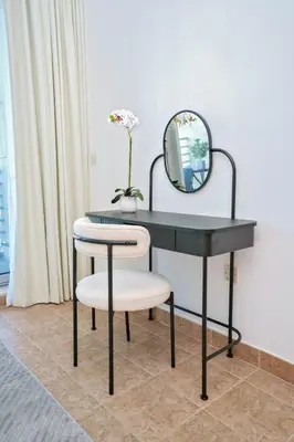 a black desk with a mirror and two chairs at Luxe 1BR Hamilton Residency Business Bay with balcony in Dubai
