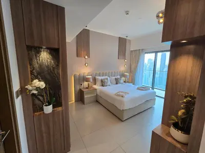 a bedroom with a bed and a large window at Highend Luxury 2BR Direct Burj Khalifa & Fountain Views in Dubai