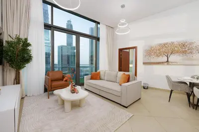 a living room with a couch and a table at Downtown Luxury Two Bedroom Apartment I Conntected To Dubai Mall And Metro I Steps Away From Burj Khalifa I by Luxury Space in Dubai