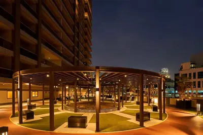 a building with a pavilion in front of it at night at Elite Downtown Residence1 Lake View Studio Balcony Apartment in Dubai