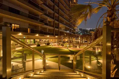 an external view of a building at night at Elite Downtown Residence1 Lake View Studio Balcony Apartment in Dubai