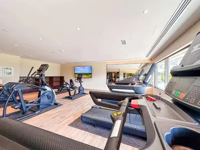 a gym with several treadmills and cardio machines at Elite Downtown Residence1 Lake View And Burj view 1 bedroom in Dubai