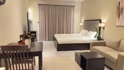 a hotel room with a bed and a couch at Elite Downtown Residence1 Lake View And Burj view 1 bedroom in Dubai