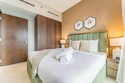 a bedroom with a large bed with white pillows at Canal View, Easy Downtown Access, Reva Residences, Business Bay by Deluxe Holiday Homes in Dubai