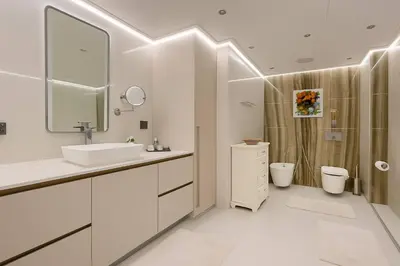 a white bathroom with a sink and a shower at Unique Sea View 1BDR Apartment | Anantara Palm in Dubai