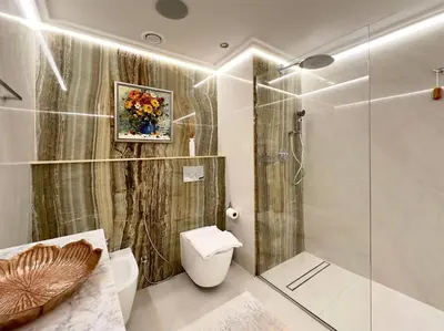 a bathroom with a toilet and a shower at Unique Sea View 1BDR Apartment | Anantara Palm in Dubai