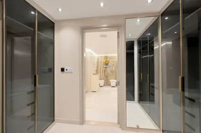 a hallway with glass doors leading to a bathroom at Unique Sea View 1BDR Apartment | Anantara Palm in Dubai