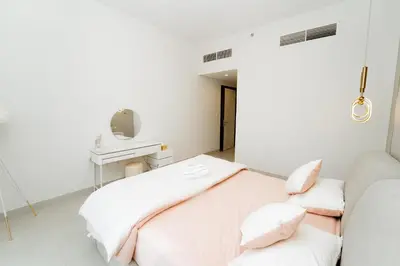 a hospital room with two beds and a couch at Luxury 2BR in Al Kifaf with Frame View, Near Trade Center, Metro Access in Dubai