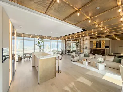 an open living room with a kitchen and a living room at VayK - Bright and Modern One Bedroom in JVC in Dubai