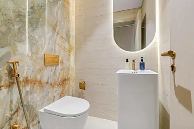 a bathroom with a white toilet and a mirror at VayK - Contemporary One Bedroom Apartment in JVC in Dubai