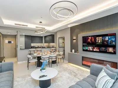 a living room with a couch and a fireplace at Aurora - 2BR Paramount Hotel Midtown Dubai, Skyline & Burj Khalifa View in Dubai