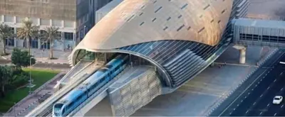 a train station with a train on top of a building at Studio in discovery garden Near gardens metro station in Dubai