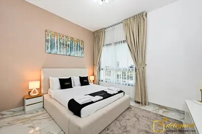 a bedroom with a bed and a large window at Cozy Majan family apartment hosted by Deleguest in Dubai