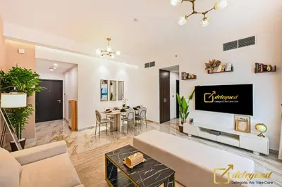 a living room with a couch and a tv at Cozy Majan family apartment hosted by Deleguest in Dubai