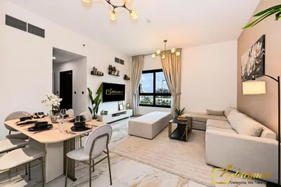 a living room with a table and a couch at Cozy Majan family apartment hosted by Deleguest in Dubai