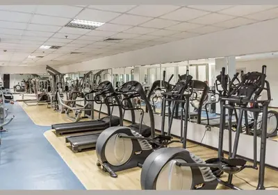 a gym with rows of treadmills and elliptical machines at Cloud 9 Room Marina in Dubai