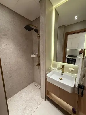 a bathroom with a sink and a mirror at Modern Studio Apartment In JVC in Dubai