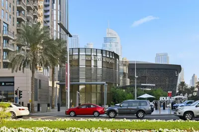 a city street with cars parked in front of a building at Modern 1 Bed in the Heart of Downtown 5 mins walk from Burj Khalifa and Dubai Mall in Dubai