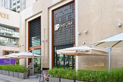 a restaurant with umbrellas in front of a building at Modern 1 Bed in the Heart of Downtown 5 mins walk from Burj Khalifa and Dubai Mall in Dubai