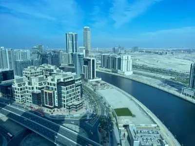 an aerial view of a city with a river and buildings at Bright and Modern 1-Bed Studio with Sofa in DAMAC Prive in Dubai