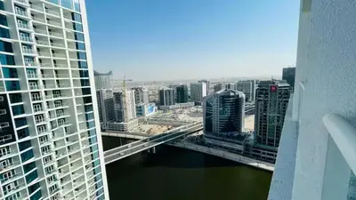 a view of a city with a bridge and buildings at Bright and Modern 1-Bed Studio with Sofa in DAMAC Prive in Dubai