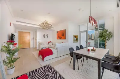 a living room with a white couch and a table at FiveX Premium 2BR at Trident Waterfront Marina in Dubai