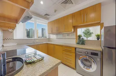 a large kitchen with a sink and a dishwasher at FiveX Premium 2BR at Trident Waterfront Marina in Dubai
