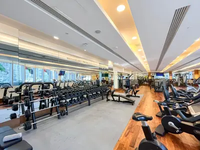 a gym with rows of treadmills and machines at Luxurious 1 BR Apt Kempinski Central Avenue in Dubai