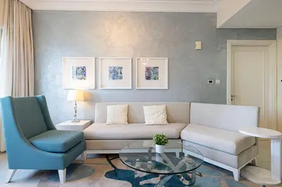 a living room with a couch and a glass table at Damac Maison Mall Street! 2 Bedroom, 2 minute to Dubai Mall! in Dubai