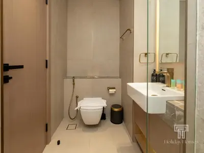 a bathroom with a toilet and a sink at Brand New Luxe Studio Sauna, Gym&Pool With Access in Dubai
